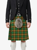 Person wearing a traditional Scottish kilt with a tartan pattern on a white background
