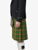 Person wearing a black jacket and green plaid kilt on a white background