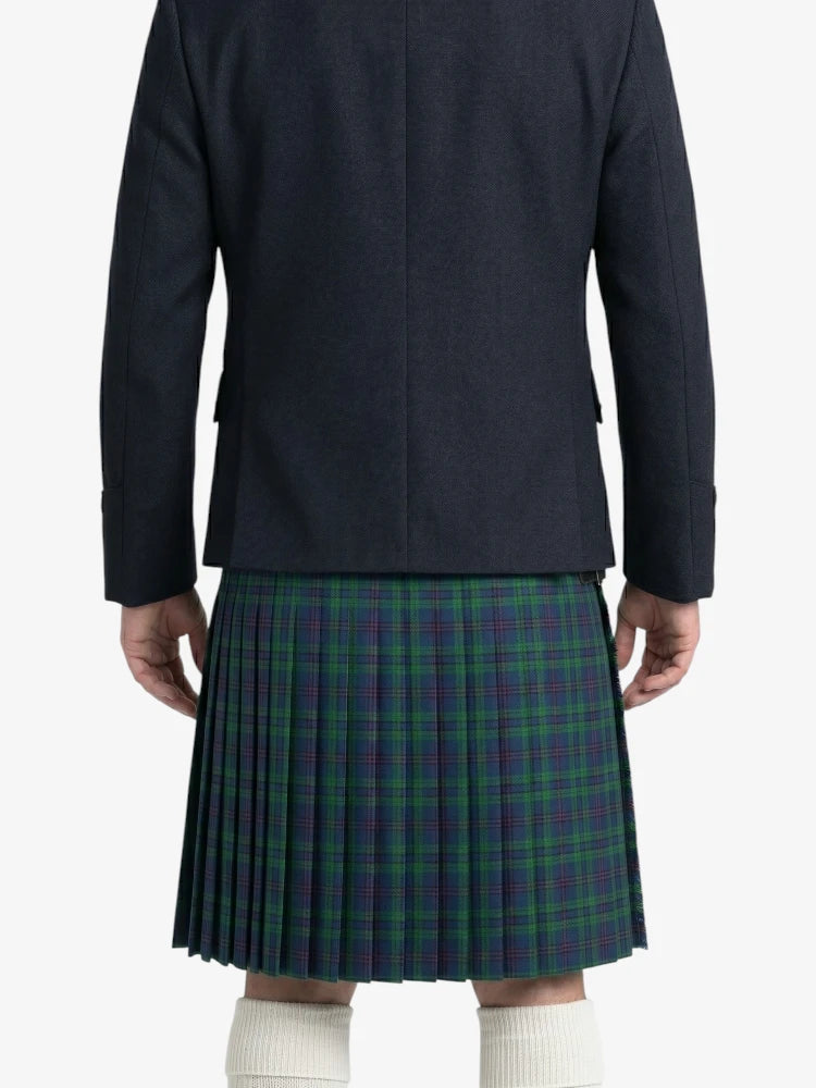 Person wearing a dark jacket and plaid kilt on a white background