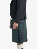 Person wearing a dark jacket and plaid kilt on a white background
