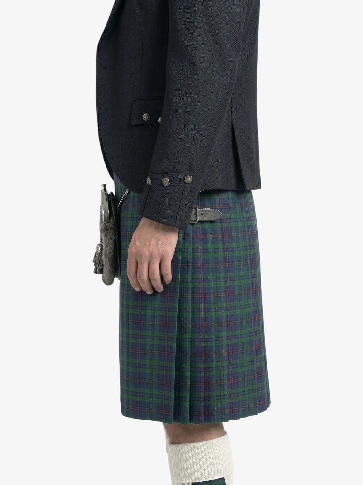 Person wearing a dark jacket and plaid kilt on a white background
