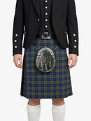Person wearing a traditional Scottish kilt with a tartan pattern on a white background
