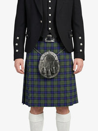 Person wearing a traditional Scottish kilt with a tartan pattern on a white background