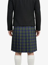 Person wearing a black jacket and plaid kilt on a white background