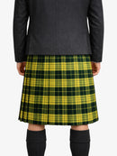 Person wearing a green and yellow plaid kilt with a dark coat on a white background