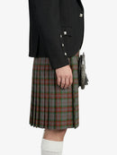 Person wearing a black jacket and plaid kilt on a white background