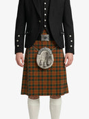 Person wearing a black jacket and red plaid kilt with a silver tartan plaque on a white background