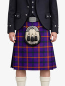 Person wearing a purple plaid kilt with a black jacket on a white background