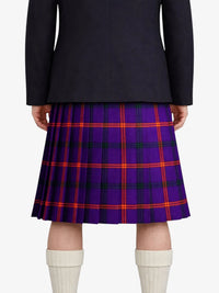 Person wearing a black jacket and purple plaid kilt on a white background