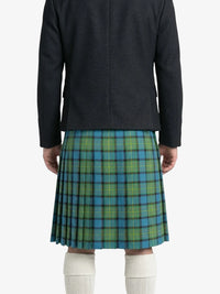 Person wearing a dark jacket and green plaid kilt on a white background