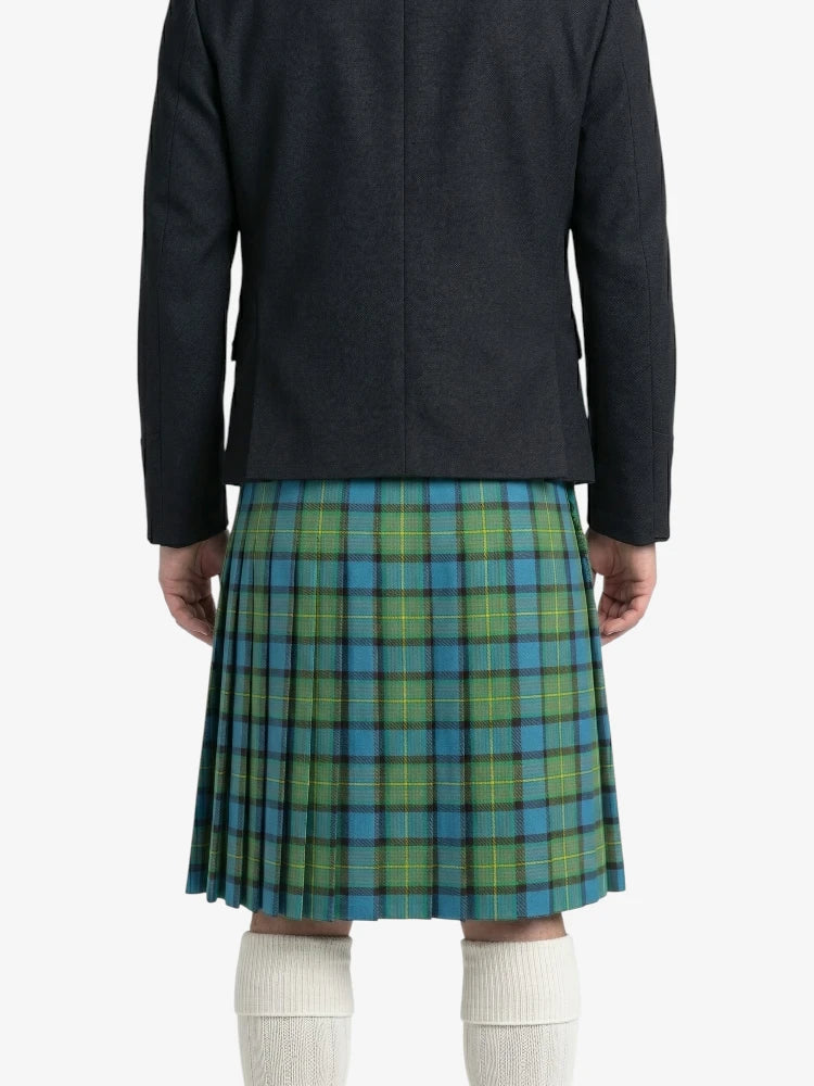 Person wearing a dark jacket and green plaid kilt on a white background
