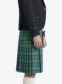 Person wearing a dark jacket and green plaid kilt on a white background