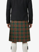 Person wearing a green plaid kilt with a black jacket on a white background