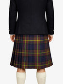 Person wearing a black coat and plaid kilt on a white background