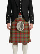 Person wearing a traditional Scottish kilt with a tartan pattern on a white background