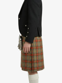Person wearing a black jacket and plaid kilt on a white background