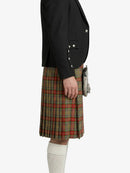 Person wearing a black blazer and plaid kilt on a white background