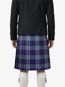 Person wearing a black jacket and plaid kilt on a white background