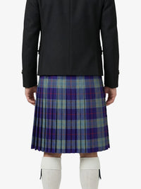 Person wearing a black jacket and plaid kilt on a white background