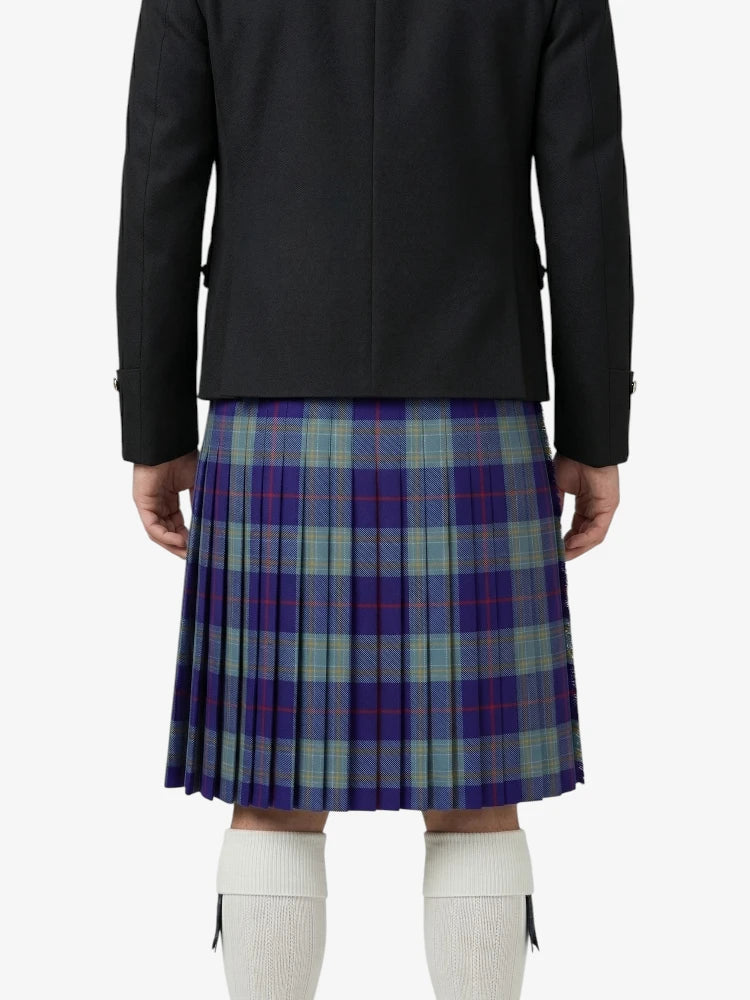 Person wearing a black jacket and plaid kilt on a white background