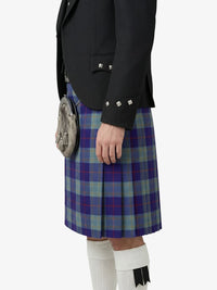 Person wearing a black jacket and blue plaid kilt on a white background