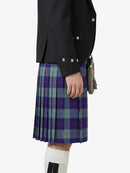 Person wearing a black jacket and a plaid kilt on a white background