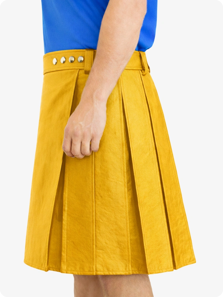 Yellow pleated skirt worn with a blue top on a white background