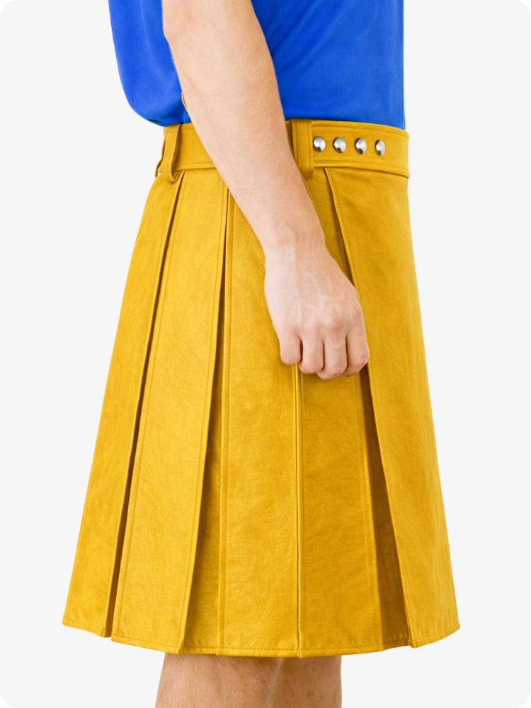 Yellow pleated skirt with studded details worn by a person on a white background