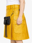 Yellow skirt with black bag held by a person on a white background