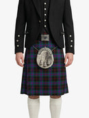 Person wearing a black jacket and tartan kilt on a white background