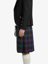 Person wearing a black jacket and plaid kilt on a white background