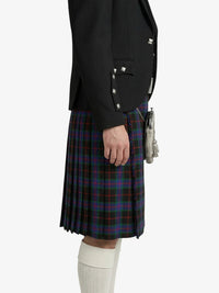 Person wearing a black jacket and plaid kilt on a white background