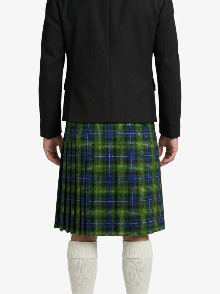 Person wearing a black coat and green plaid kilt on a white background