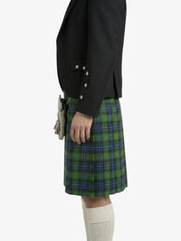 Person wearing a black jacket and green plaid kilt on a white background