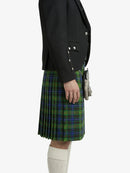 Person wearing a black blazer and green plaid kilt on a white background