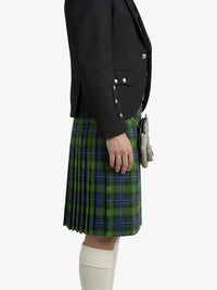 Person wearing a black blazer and green plaid kilt on a white background