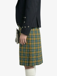 Person wearing a dark jacket and green plaid kilt on a white background