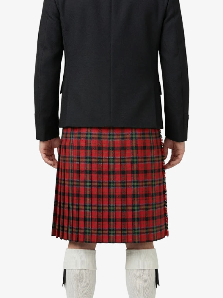 Person wearing a black coat and red plaid kilt on a white background