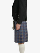 Person wearing a black jacket and plaid kilt on a white background