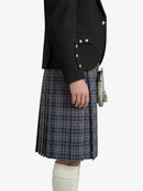 Person wearing a black jacket and plaid kilt on a white background