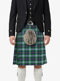 Person wearing a traditional Scottish kilt with a tartan pattern on a white background
