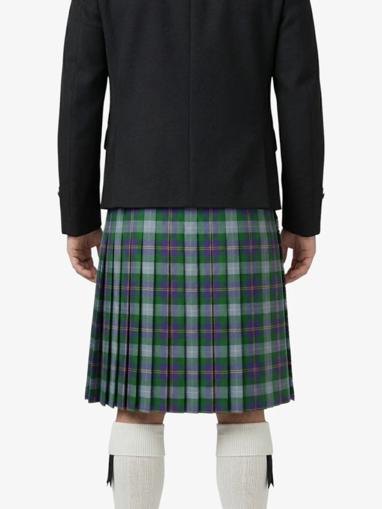Person wearing a black jacket and green plaid kilt on a white background