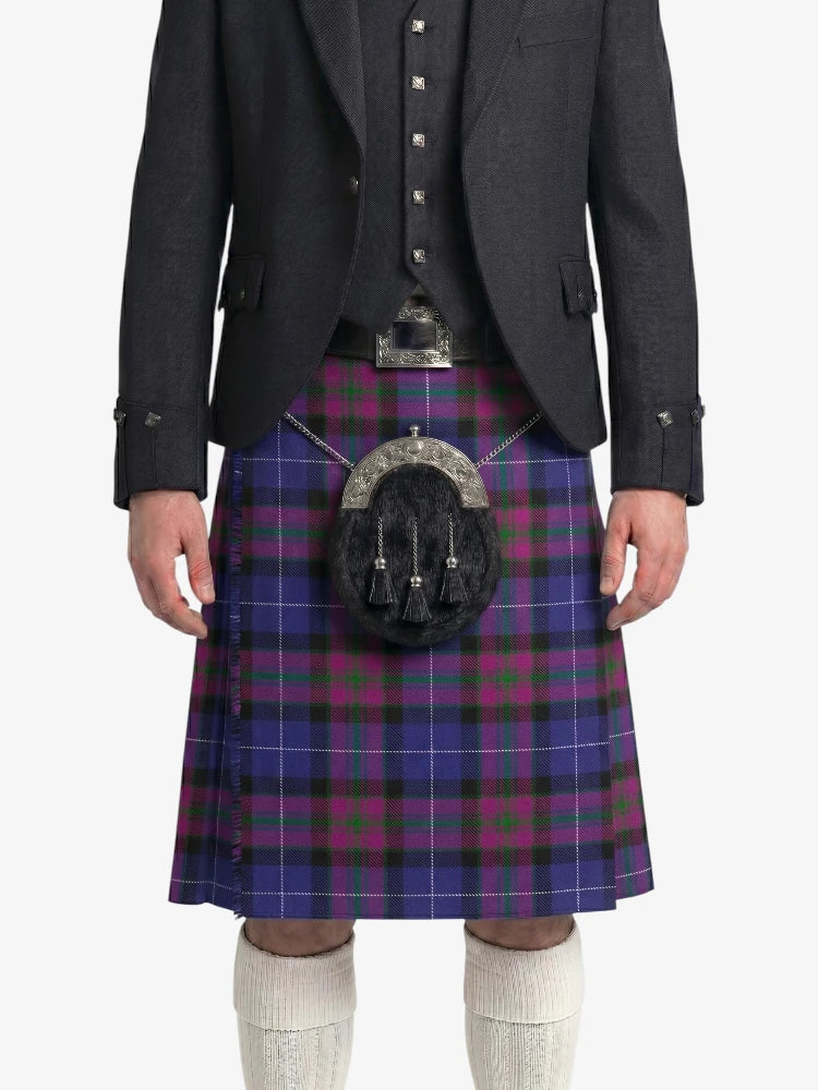 Person wearing a dark gray jacket and a purple plaid kilt on a white background