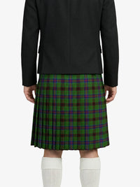 Person wearing a black jacket and green plaid kilt on a white background