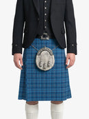 Person wearing a blue plaid kilt with a black jacket on a white background