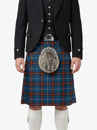 Person wearing a traditional Scottish kilt with a sporran on a white background