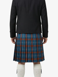 Person wearing a black jacket and blue plaid kilt on a white background