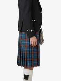Person wearing a black jacket and plaid kilt on a white background