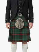 Person wearing a black jacket, green plaid kilt, and white knee-high socks on a white background