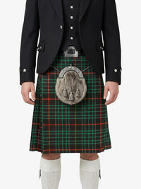 Person wearing a black jacket, green plaid kilt, and white knee-high socks on a white background
